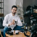 smiling technology blogger putting on new smart watch