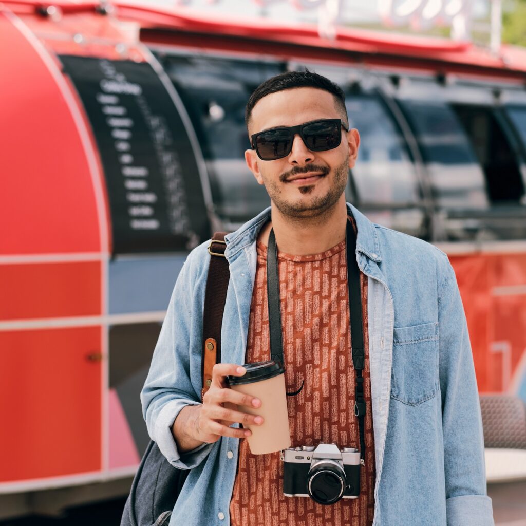young male photographer with drink and photocamera dhddjav.jpg